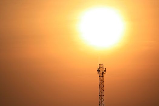 Silhouette of communication antenna in a woderful orange sunset