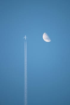 Airplane in the sky near the moon