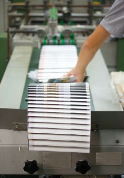 Print shop - Finishing line. Post press finishing line machine: cutting, trimming, paperback.