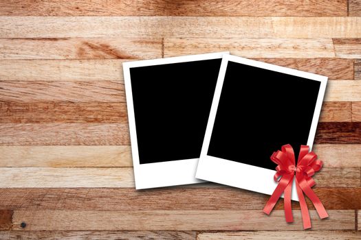 Blank photo frames on wood background