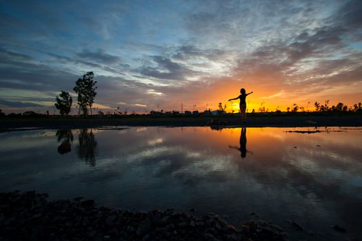 silhouette women and reflection sunset