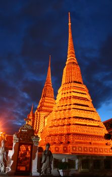 The pagodas of Wat Pho temple at night. Bangkok, Thailand