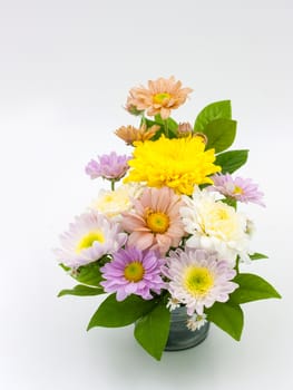 Colorful flower bouquet arrangement in vase isolated on white background