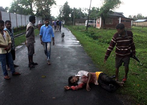 INDIA, Tinsukia: [WARNING: graphic content] A man lies bloodied on the ground after a protest where at least eleven people were killed, and twelve others injured, when a high-voltage electric cable was hit by stray police fire and fell on protesters in Tinsukia, Assam, India on April 11, 2016. Protesters had reportedly stormed a police station, calling on police to hand over a group of suspects arrested for killing two people last week. Police opened fire to disperse protesters, and a stray bullet severed the power line, which fell and electrocuted demonstrators.