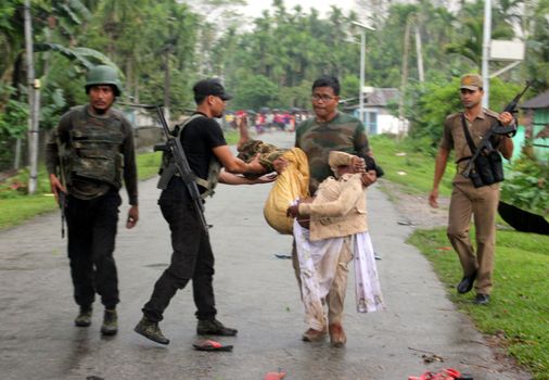 INDIA, Tinsukia: [WARNING: graphic content] Officers carry a man's body after a protest where at least eleven people were killed, and twelve others injured, when a high-voltage electric cable was hit by stray police fire and fell on protesters in Tinsukia, Assam, India on April 11, 2016. Protesters had reportedly stormed a police station, calling on police to hand over a group of suspects arrested for killing two people last week. Police opened fire to disperse protesters, and a stray bullet severed the power line, which fell and electrocuted demonstrators.