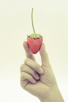 Strawberry in woman  hand isolated on white background - vintage effect filter