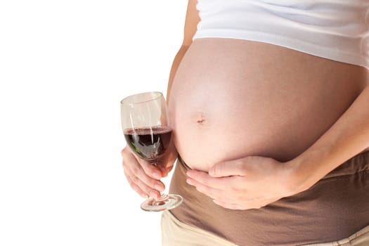 Pregnant woman holding her hand on belly and wine glass