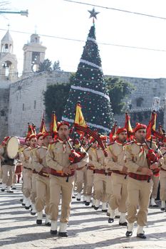 WEST BANK, Bethlehem : A bag pipe orchestra plays in the streets outside of the church of Nativity on December 24, 2015 in Bethlehem, West Bank. Every year thousands of Christian pilgrims travel to the church that marks the site of the cave in which Jesus is said to have been born. 