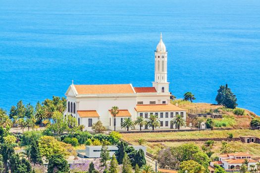 Funchal, Madeira - June 7, 2013: Church of Sao Martinho - a civil parish in the municipality of Funchal. View from Pico dos Barcelo - south coast of Madeira - Atlantic Ocean in the background.
