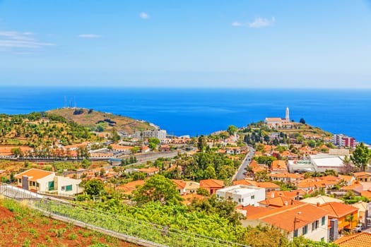 Funchal, Madeira - June 7, 2013: Church of Sao Martinho - a civil parish in the municipality of Funchal. View from Pico dos Barcelo - south coast of Madeira - Atlantic Ocean in the background.