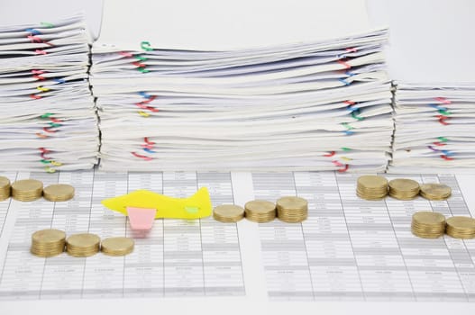 Airplane among step pile of gold coins on finance account have overload of paperwork with colorful paperclip as background.