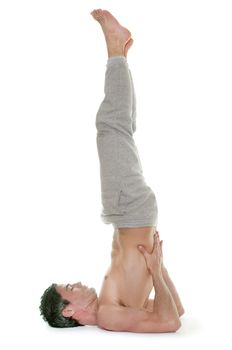 man doing yoga in front of white background