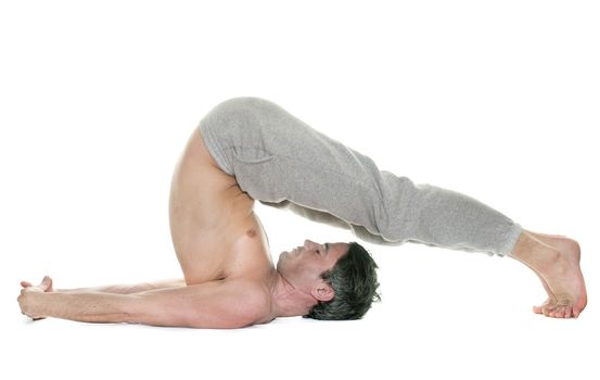 man doing yoga in front of white background