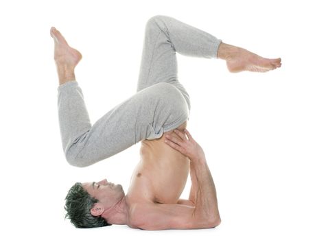 man doing yoga in front of white background