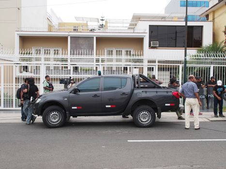 PERU, Lima : Peruvian police guard the entrance of the Mossack Fonseca offices during a raid in Lima on April 11, 2016.Peruvian authorities raided a branch of Mossack Fonseca in Lima, which is located directly across the road from the Panamanian embassy. They said they were looking for evidence Peruvians used the firm for tax avoidance. /