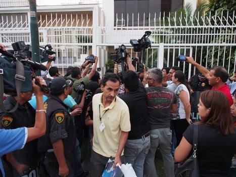 PERU, Lima : Tax authorities retrieve documents from the Mossack Fonseca offices escorted by police during a raid in Lima on April 11, 2016.Peruvian authorities raided a branch of Mossack Fonseca in Lima, which is located directly across the road from the Panamanian embassy. They said they were looking for evidence Peruvians used the firm for tax avoidance.