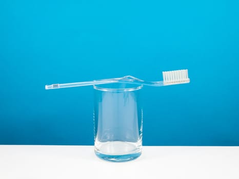 The clear toothbrush with small glass for brushing the teeth.