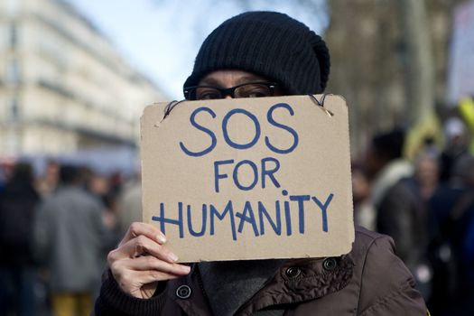 FRANCE, Paris: A woman holds a sign as hundreds of protesters gather on the Place de La Republique in Paris as part of demonstrations by the Nuit Debout (Up All Night) movement, on April 11, 2016. French Prime Minister Manuel Valls unveiled measures to help young people find work, aiming to quell weeks of protests against the government's proposed reforms to labour laws. Young people have been at the forefront of mass demonstrations against the reforms over the past month, which the government argues are aimed at making France's rigid labour market more flexible.