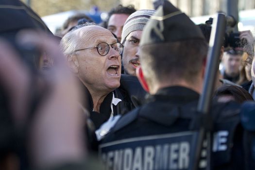 FRANCE, Paris: A man clashes with riot police during a rally held on the Place de La Republique in Paris as part of demonstrations by the Nuit Debout (Up All Night) movement, on April 11, 2016. French Prime Minister Manuel Valls unveiled measures to help young people find work, aiming to quell weeks of protests against the government's proposed reforms to labour laws. Young people have been at the forefront of mass demonstrations against the reforms over the past month, which the government argues are aimed at making France's rigid labour market more flexible.