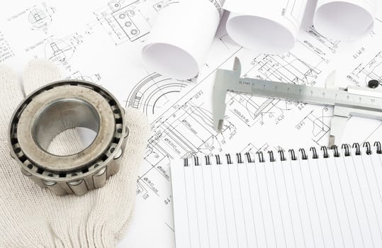 Architecture plan and rolls of blueprints with metal rings and notebook. Building concept