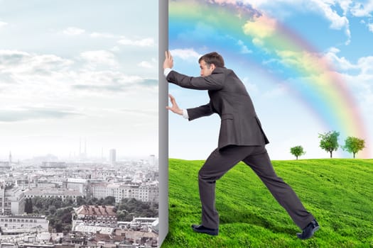 Businessman changing city on nature landscape with rainbow and green grass