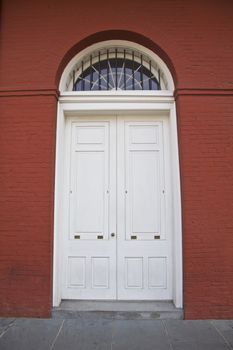 White door, red building in New Orleans, Louisiana, USA