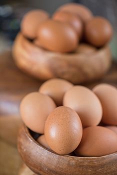 Fresh eggs at wooden plate closeup