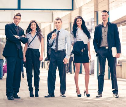 Small group of young business people standing in the passage of the building.