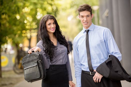 Close-up of a young businessmen and businesswomen walking outside. 