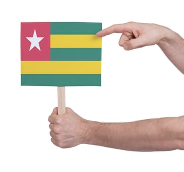 Hand holding small card, isolated on white - Flag of Togo