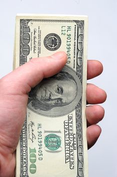 100 dollars bill on hand on white background