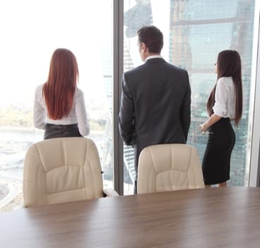 Rear view of business people looking at window