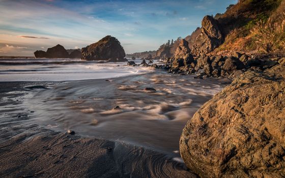 Long-exposure color image of the Pacific coastline at Sunset 