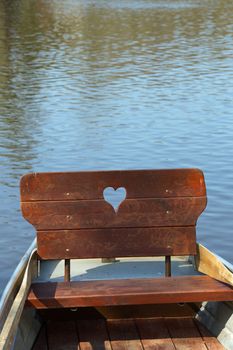 Row boat with heart on a lake