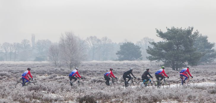 EPE, THE NETHERLANDS - MARCH 5, 2016: Cyclists under winter skies on a training ride in order to regain the fitness lost over the holidays.