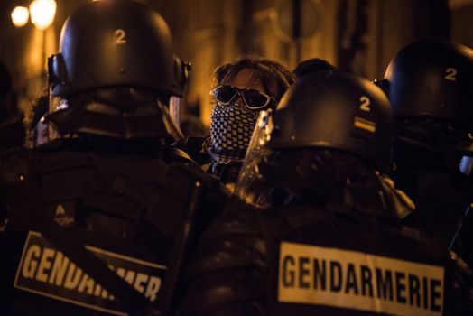 FRANCE, Paris: French police officers face protesters during a night demonstration in front of a police station in the 2nd arrondissement of Paris, on April 12, 2016. Protesters claim the release of a student arrested earlier in the day. 