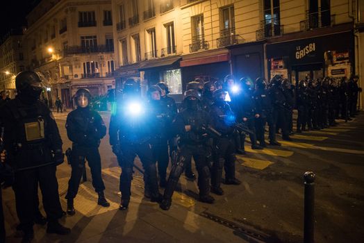 FRANCE, Paris: French riot police face protesters during a night demonstration in front of a police station in the 2nd arrondissement of Paris, on April 12, 2016. Protesters claim the release of a student arrested earlier in the day. 