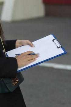 girl with French manicure keeps clip board