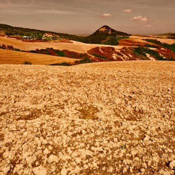 Plowed Sloping Hills of Tuscany in the Autumn at Sunset, Vintage Style Toned Picture