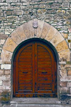 Wooden Ancient Spanish Door in Historic Center, Vintage Style Toned Picture