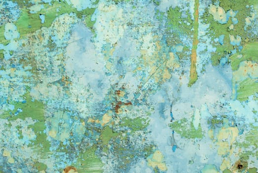 fragment of an iron surface is covered with emerald and blue color paint, which has long been under the influence of different climatic conditions