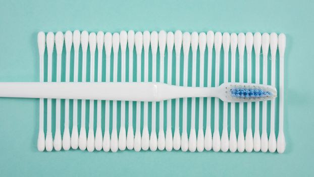 The group of purified white cotton buds with the white toothbrush.