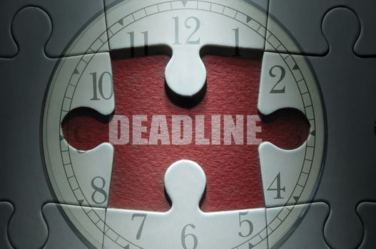 Missing piece from a clock jigsaw puzzle with deadline in the center 