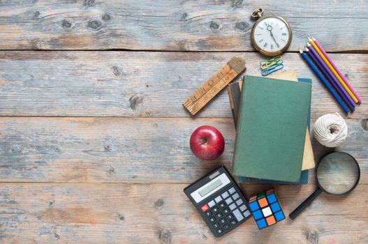 School stationery accessories on a wooden table with space for text 