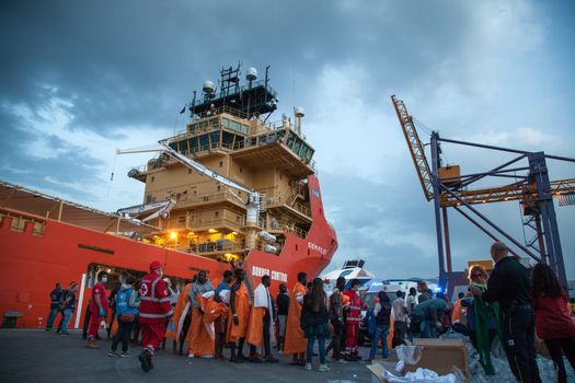 ITALY, Palermo: Migrants line up after getting off of the Siem Pilot on April 13, 2016 in Palermo, Italy.The vessel has been a major transporter of migrants fleeing the Middle East and Africa to Europe. 