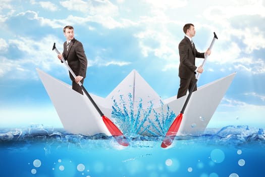 Two businessmen in paper boat rowing in different ways in blue sea, business concept