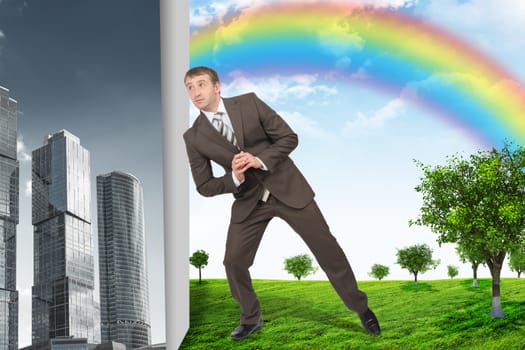 Businessman changing grey city on nature landscape with rainbow