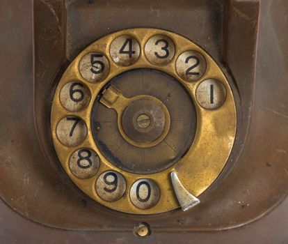 Closeup of vintage telephone dial, scratched and filthy