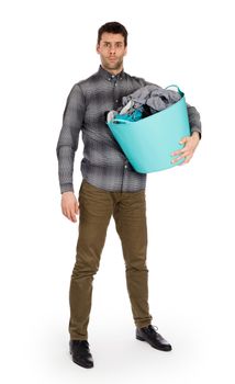 Full length portrait of a young man holding a laundry basket isolated on white background