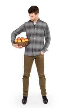 Healthy man with bowl full of apples, isolated on white